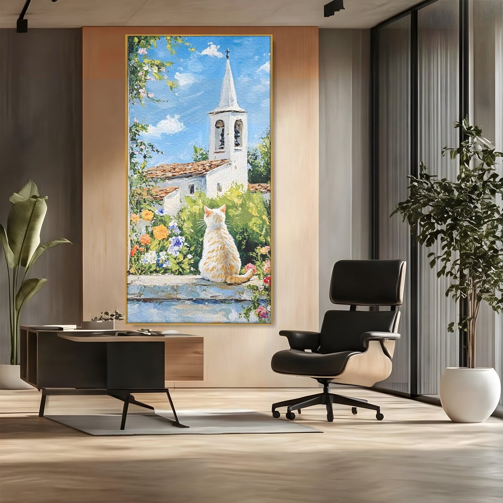 Tablou canvas cu tablou pictura cu pisica alba si biserica, in rama de aluminiu auriu, pe perete intr-un birou